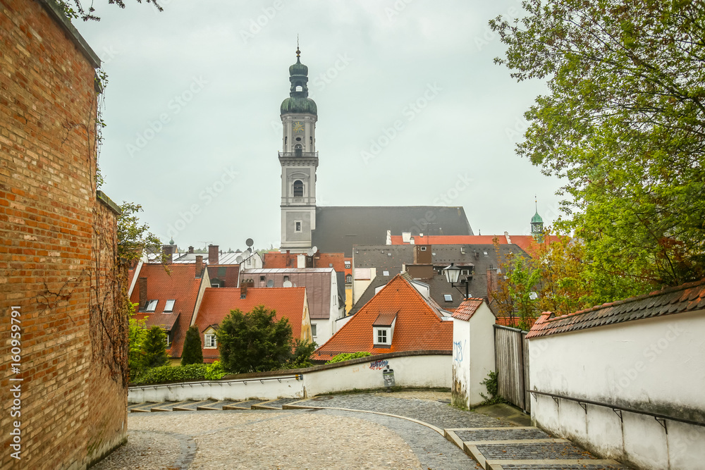 A view of St Georges Church belfry above the city roofs in Freising, Germany.