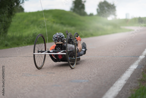 man on recumbent bicycles on a asphalt road photo