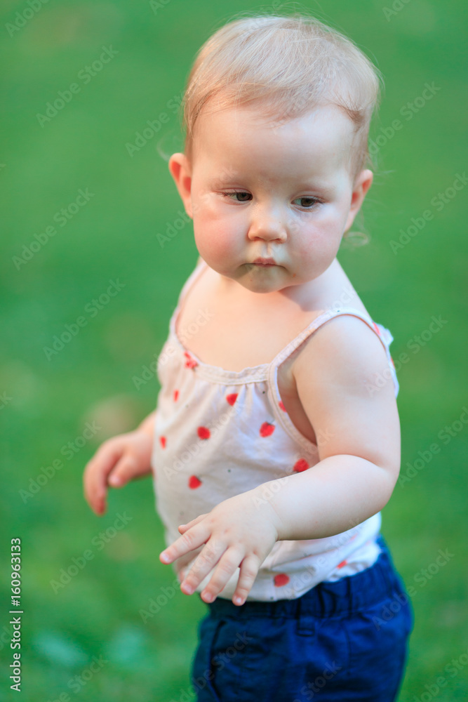 Cute one year old baby girl walking in the park Cute one year old baby girl walking in the park