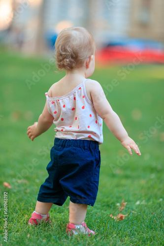 Cute one year old baby girl walking in the park © Ivica Drusany