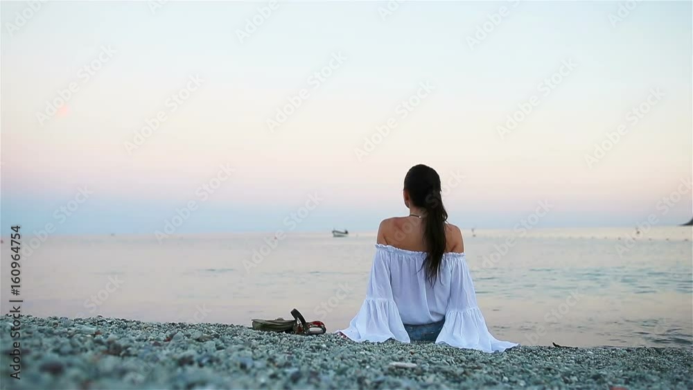 Young happy woman on the european beach in Monterosso, Cinque Terre in Italy. SLOW MOTION Young happy woman on the european beach in Monterosso, Cinque Terre in Italy. SLOW MOTION