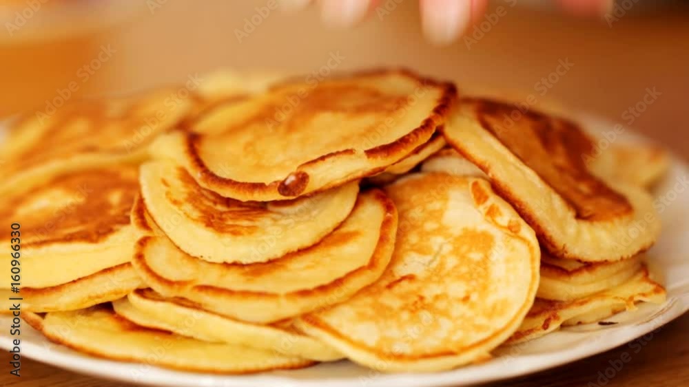A heap of thick pancakes on the plate A heap of thick pancakes on the plate