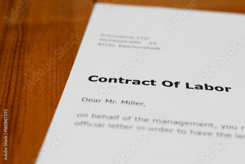 A letter on a wooden table - employment agreement