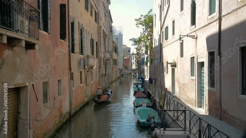 Romantic tour in gondola, rowed by a gondolier in the venice canal. photo