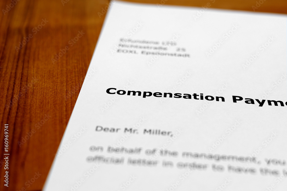 A letter on a wooden table - compensation payment