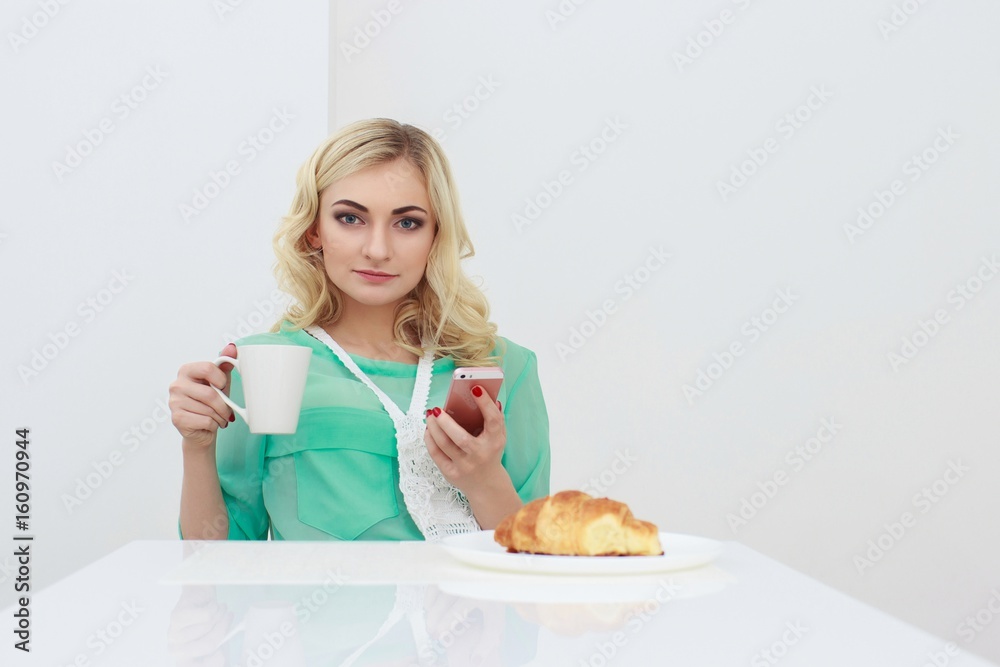 Young smiling woman having breakfast.Morning ritual Young smiling woman having breakfast.Morning ritual