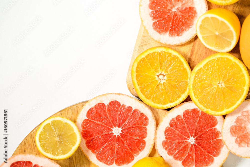Colorful vitamin C fruits on woden cutting board Colorful vitamin C fruits on woden cutting board