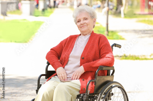 Disabled elderly woman in w...