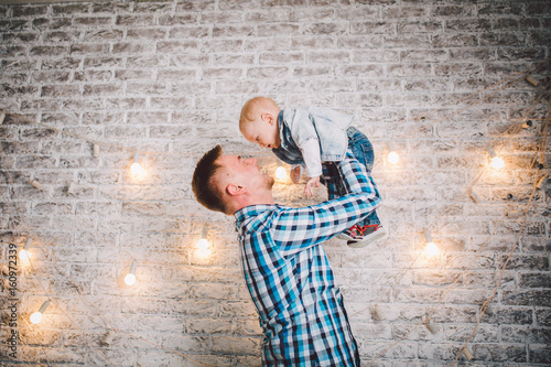 Picture of laughing dad and son dressed in plaid shirts