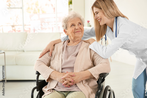 Young nurse and disabled el...