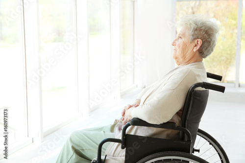 Disabled elderly woman in w...