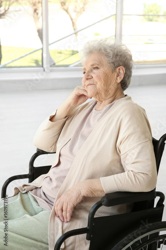 Disabled elderly woman in w...