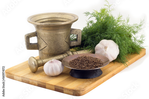 Composition of spices, Cumin, dill, garlic, vintage spice grinder isolated on white background photo