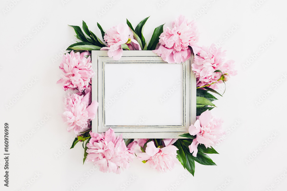 Pastel wooden frame decorated with peonies flowers, space for text. mock up - obrazy, fototapety, plakaty 