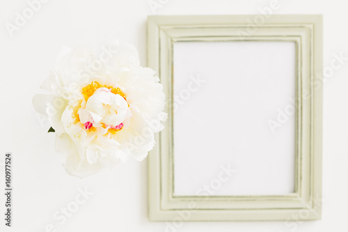 Pastel wooden frame decorated with peonies flowers  space for text. mock up