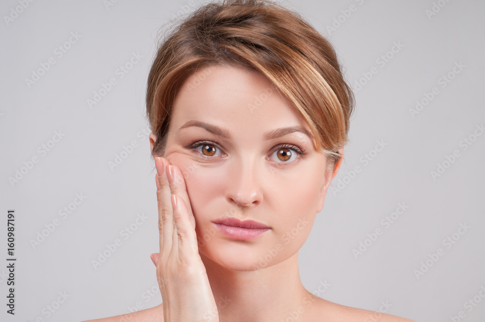 Beautiful woman with clean perfect skin touch own face. Beautiful woman with clean perfect skin touch own face.