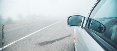 car on road in dark foggy
