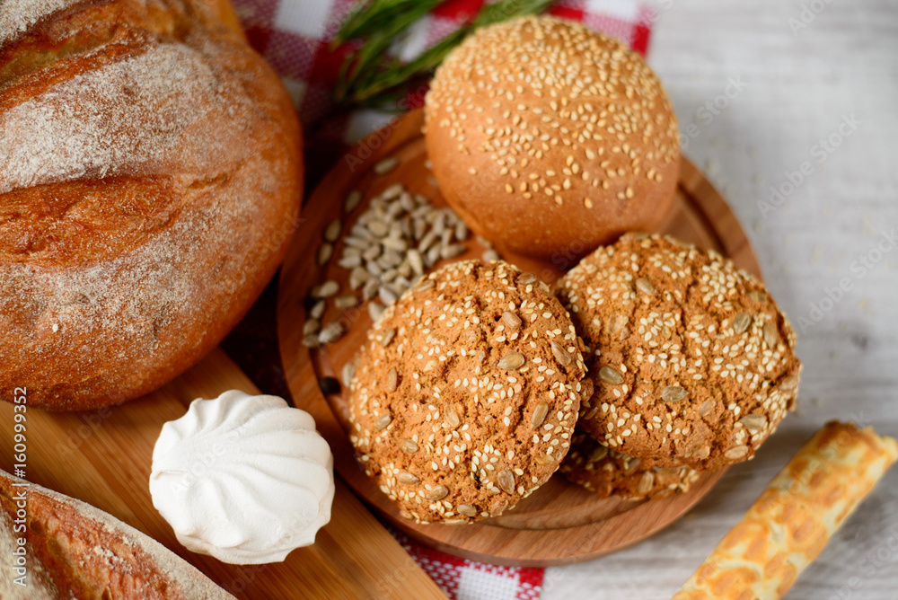 freshly baked bread. Different types of bread and rolls on Board