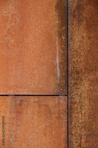 A rusty metal wall with seams and joints