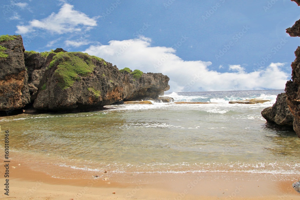 Beautiful Hidden Beach, Saipan Clear waters, soft sands and rock formations at Hidden Beach, Talafofo, Saipan