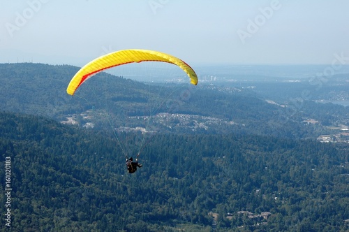 Paraglider flying over Denver Colorado suburbs