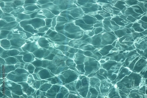 Clear water with reflections from the sun A backdrop of clear water in a swimming pool reflected by the sun, creating lines and ripples © raksyBH