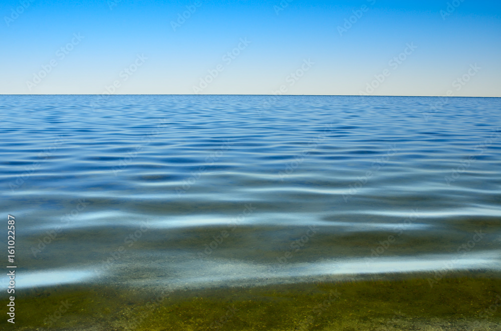 Panorama of sea waves against the blue sky