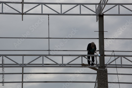 Worker working on high structure