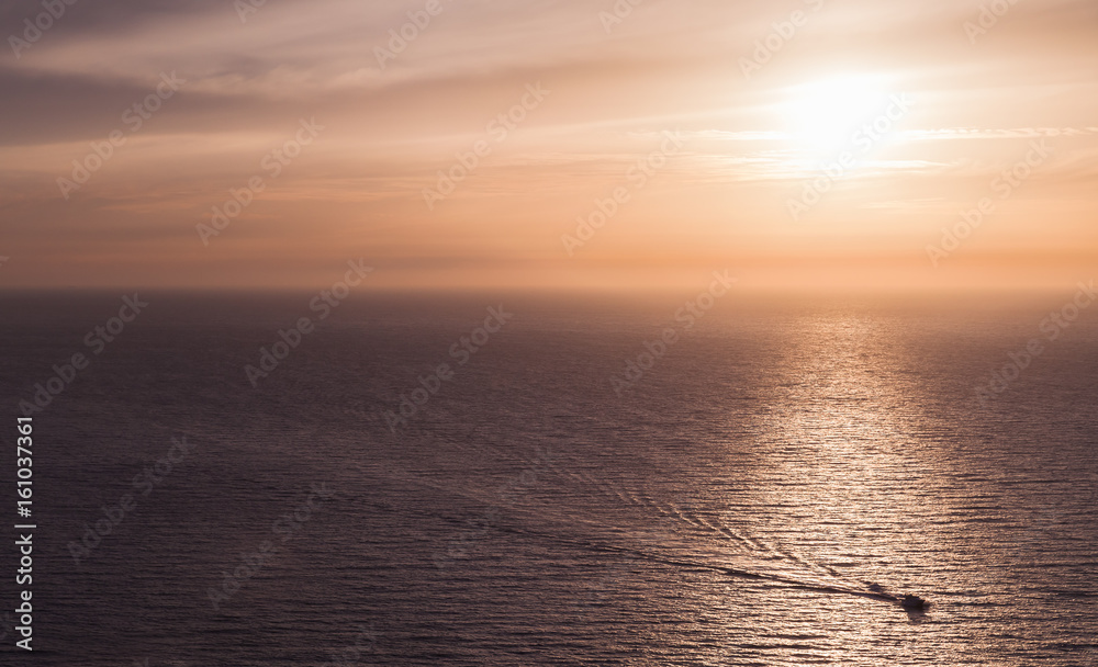 Fototapeta premium Seascape with small motorboat in sunset