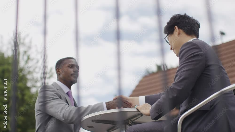Two business men shake hands after a contract has been signed