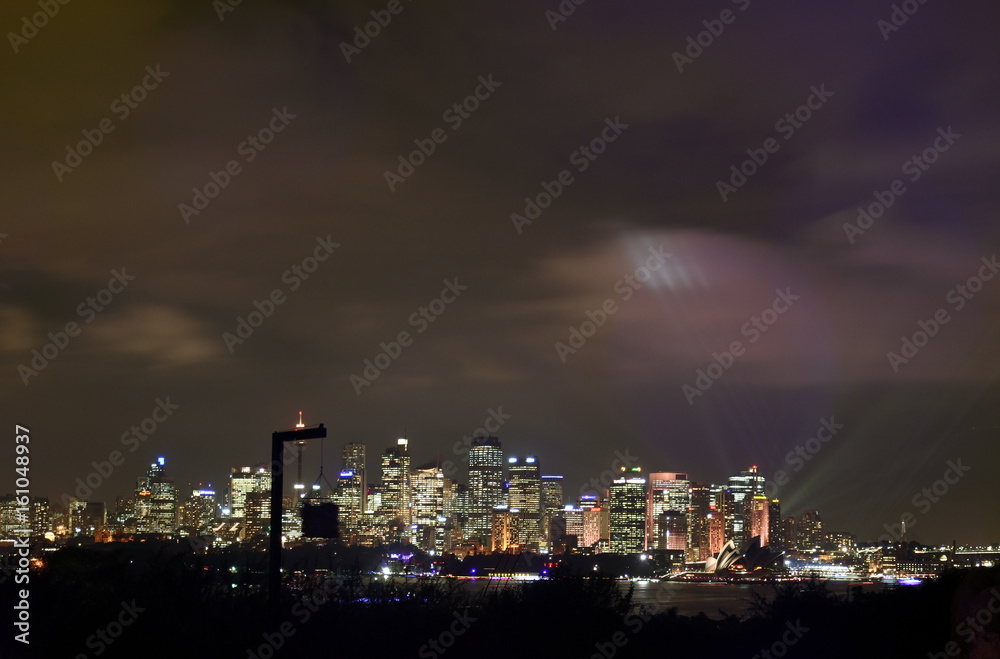Sydney cityscape at night during Vivid Sydney light festival from Taronga Zoo. Free annual outdoor event of light music and ideas.
