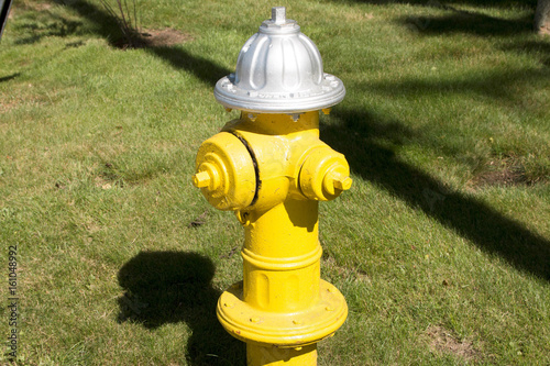 Yellwo firehydrant on the side of the road photo