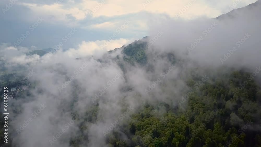 Aerial View. Flying over the high mountains in beautiful misty clouds . Aerial camera shot. Air clouds. Aerial View. Flying over the high mountains in beautiful misty clouds . Aerial camera shot. Air clouds.
