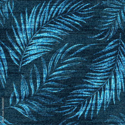Vector denim exotic palm leaf seamless pattern. Faded jeans background with tropical plants. Blue jeans cloth background