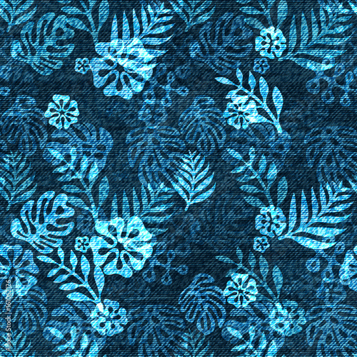 Vector denim exotic leaf seamless pattern. Faded jeans background with tropical plants. Blue jeans cloth background