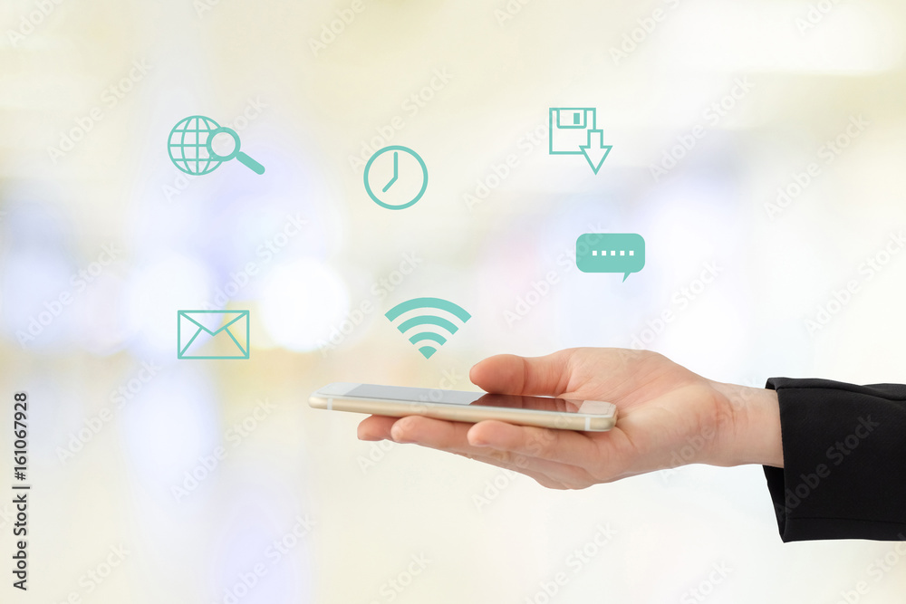 Businesswoman hand using smart-phone with internet of things icon on blurred background, business and technology concept Businesswoman hand using smart-phone with internet of things icon on blurred background, business and technology concept
