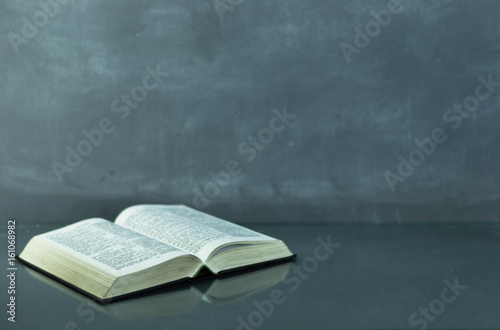 Bible on the old table. Beautiful background	 photo