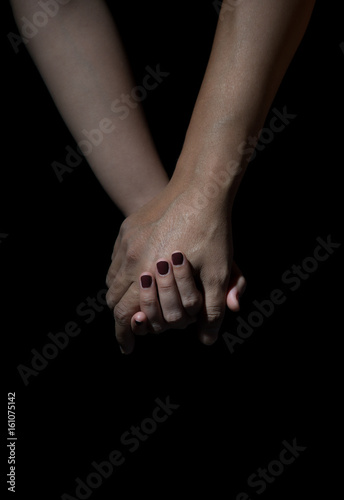 two hands of love people holding on a black background