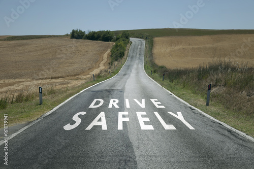 фотографія Concept drive safely message on the sunny summer asphalt country road