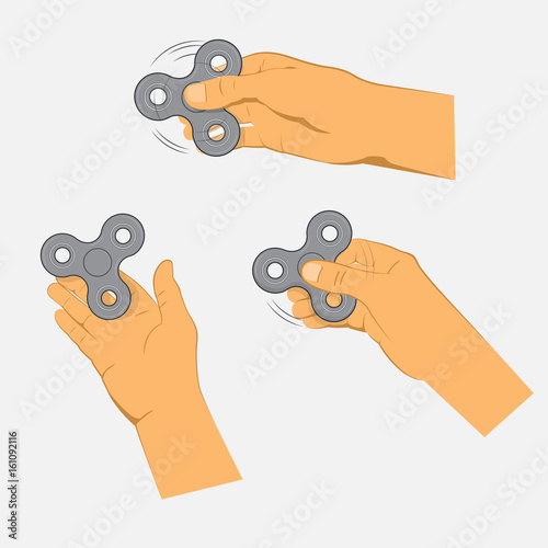 Hands holding gray fidget spinner.