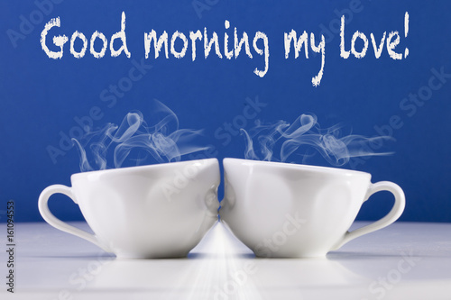Two white cups on a blue background. Good morning  my love.