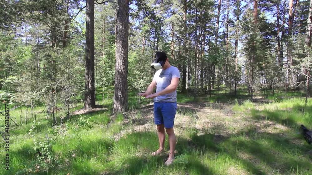 Man in 360Vr Helmet at the forest .Young Man in the woods using 360 Degrees Virtual Reality Headset Man in 360Vr Helmet at the forest .Young Man in the woods using 360 Degrees Virtual Reality Headset