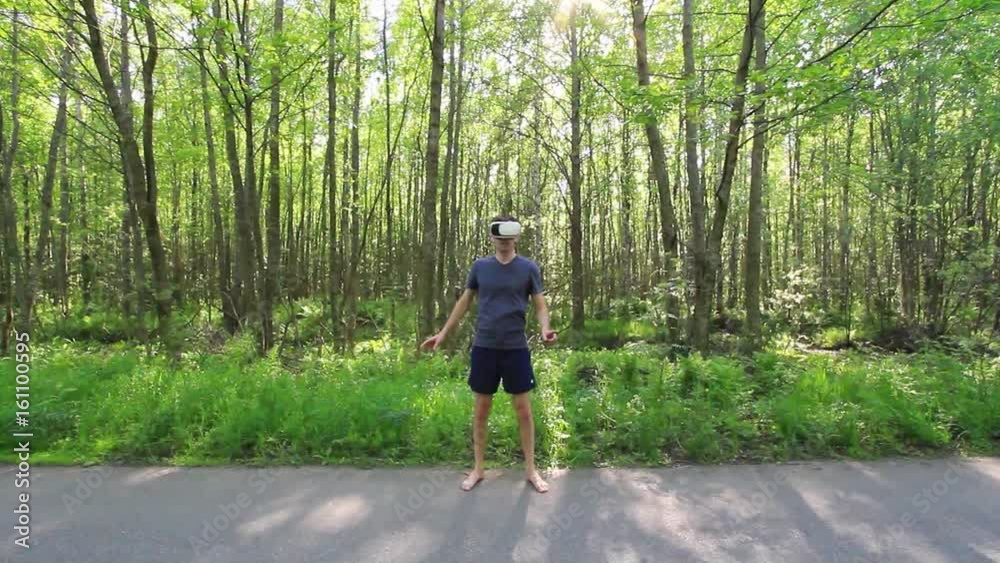 Man in 360Vr Helmet at the forest .Young Man in the woods using 360 Degrees Virtual Reality Headset Man in 360Vr Helmet at the forest .Young Man in the woods using 360 Degrees Virtual Reality Headset