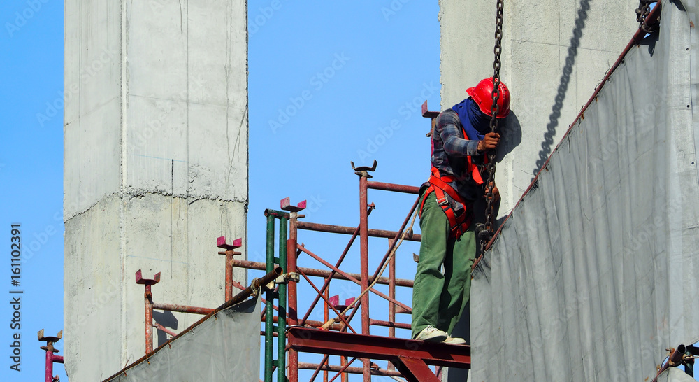 Labor man working on construction site with helmet.