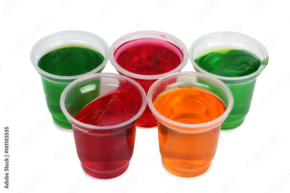 Jam in plastic with raw fruit on white background Jam in plastic with raw fruit on white background