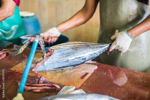 Man cutting yellofin fresh fish at male capital town market,Maldives