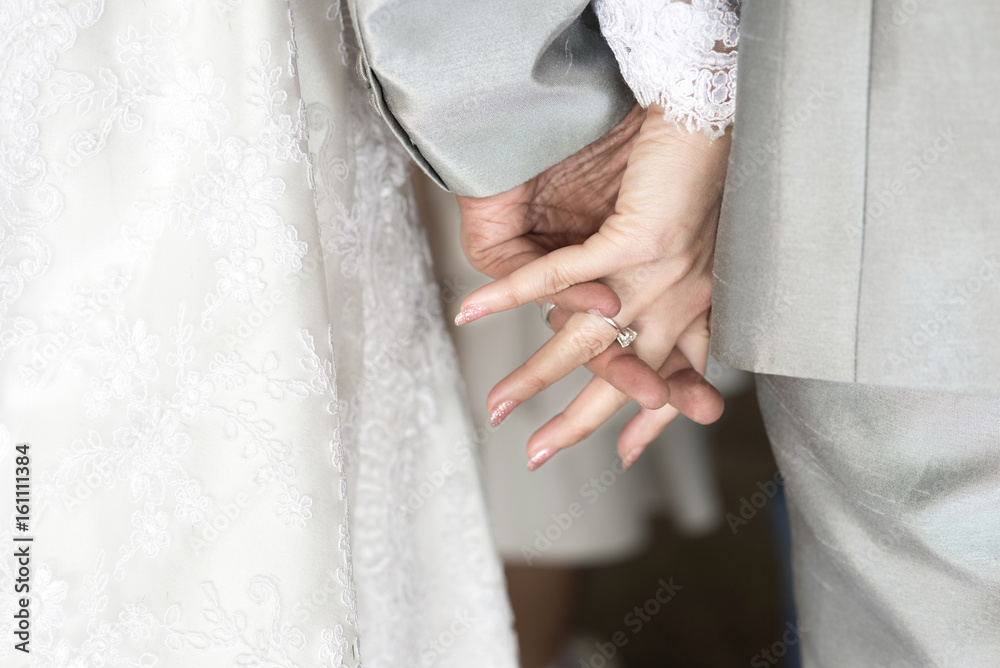 Holding hands newlyweds in wedding theme Holding hands newlyweds in wedding theme