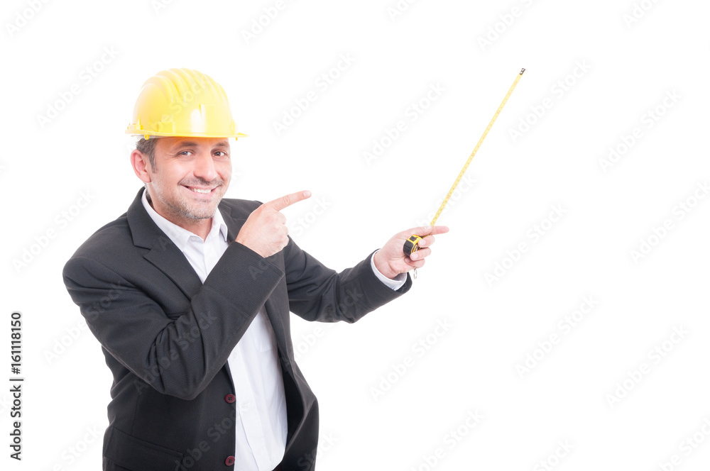 Architect wearing hardhat pointing up measuring tape Architect wearing hardhat pointing up measuring tape