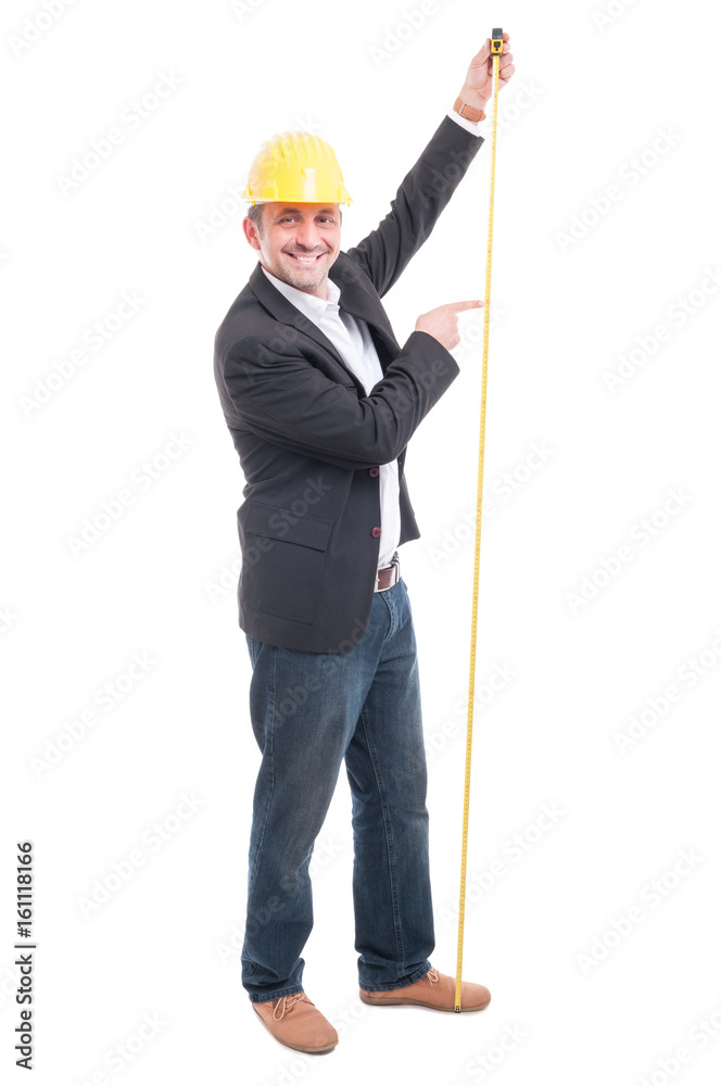 Full body of architect wearing hardhat pointing measuring tape Full body of architect wearing hardhat pointing measuring tape