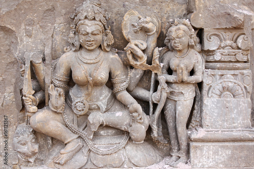 Ancient stone sculpture of two handsome young womens, India